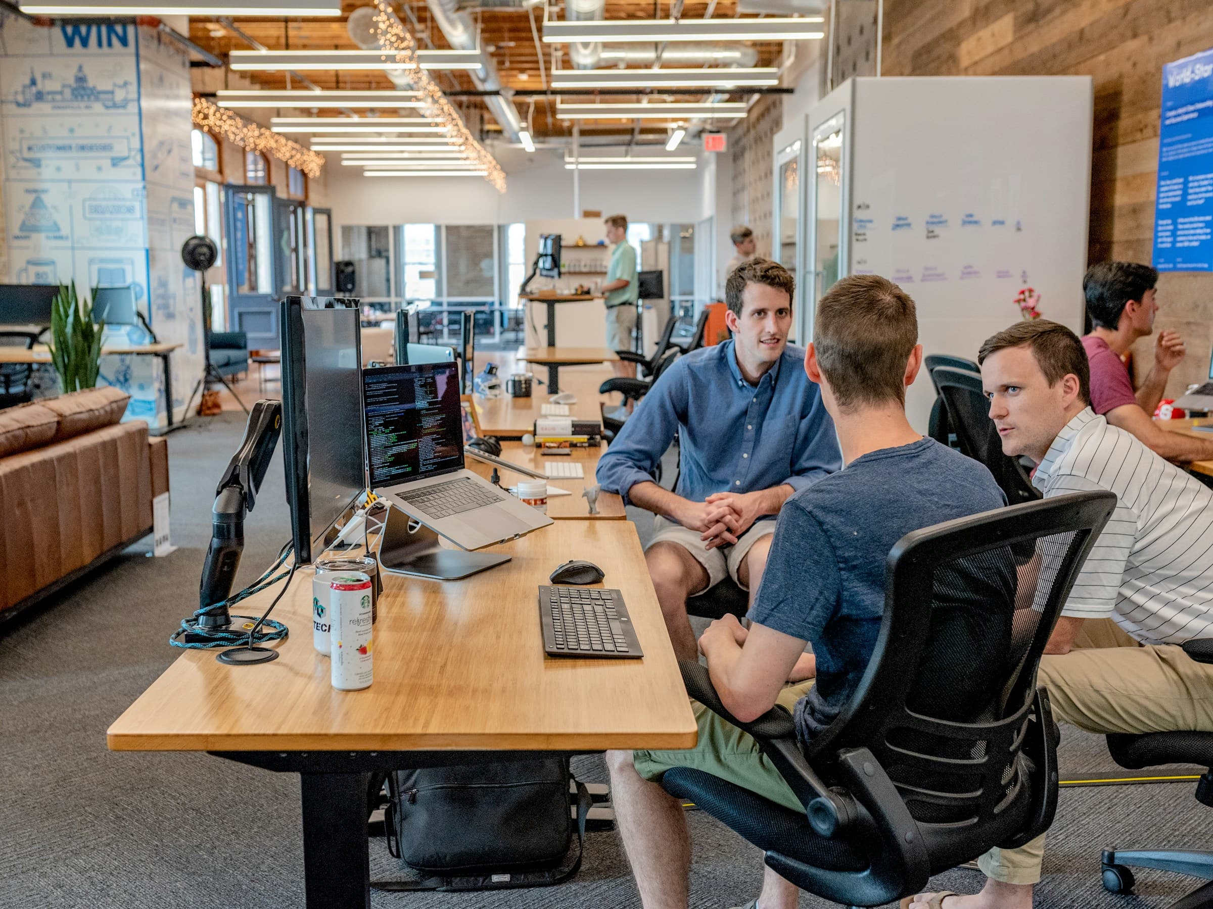 Professionals collaborating around a laptop